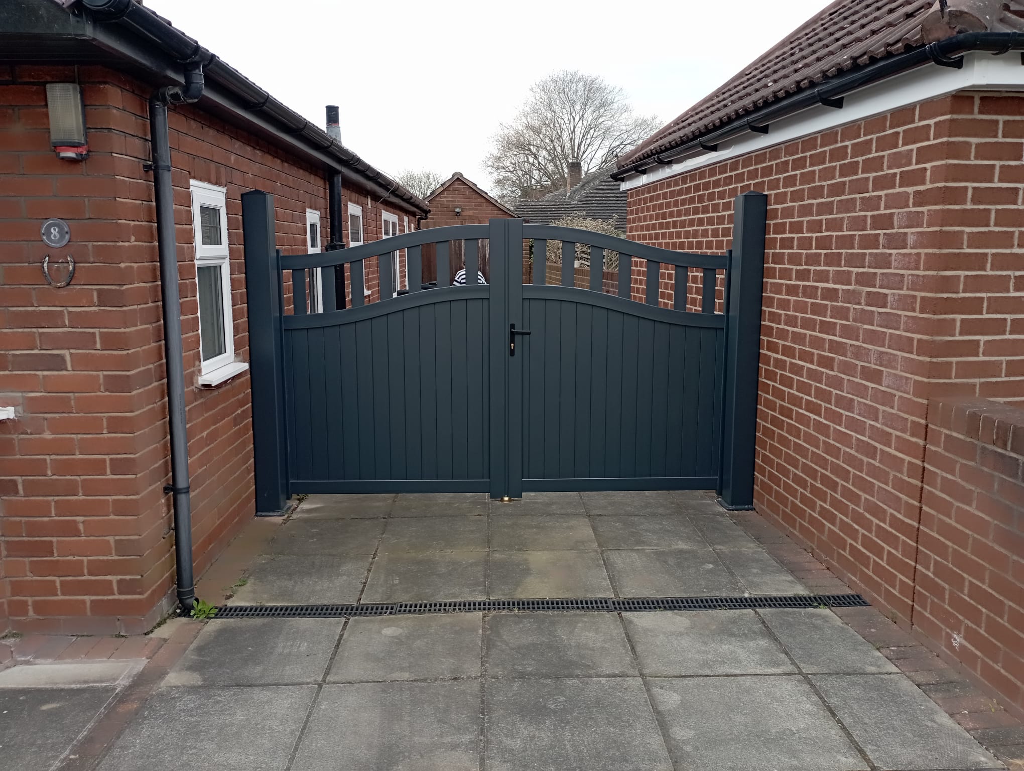 Manual aluminium gate in anthracite with an open infill installed by Henderson in Chester