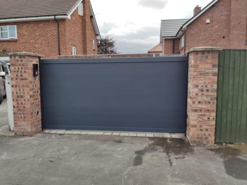 Aluminium sliding gate in anthracite installed by henderson in Chester