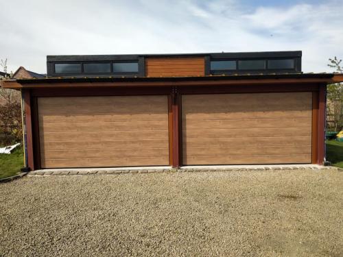 Two insulated sectional garage doors with a wood effect print finish installed by Henderson in Cheshire