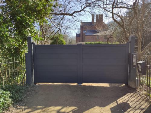 external photo of driveway aluminium gates in a horizontal design with electric operation installed by henderson in cheshire