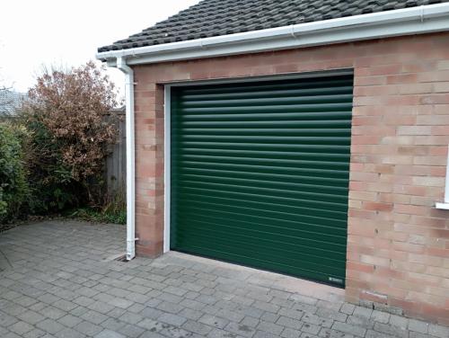 Insulated roller garage door in green installed by Henderson in Cheshire