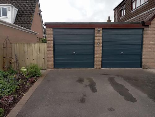 Two up and over garage doors in anthracite installed by henderson in cheshire